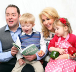 Family with young children reading