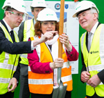 Man pointing to spade held by woman