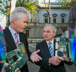 Two men holding motherboards